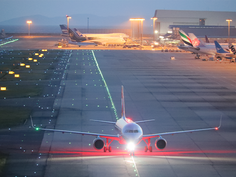 An airplane with its taxi lights illuminated.