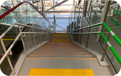 A staircase with two-tier handrails.