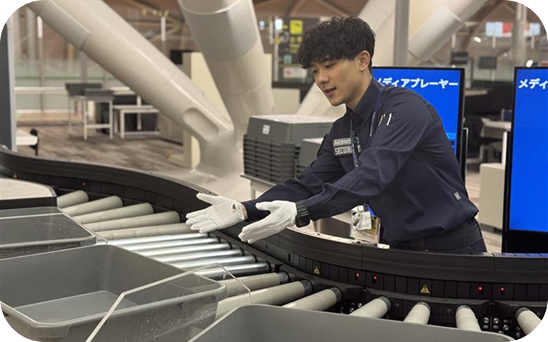 A security inspector inspecting baggage.